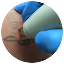 Blue tattoo needle on customer